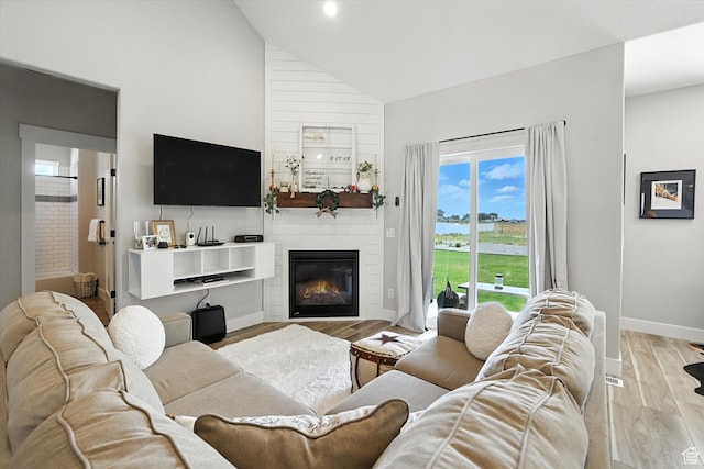 4781 N Selma Way, Erda, UT 84074 - living room with high vaulted ceiling, light wood-style floors, and a fireplace
