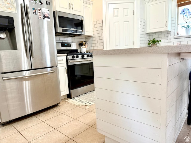 301 S 1350 W, Vernal, UT 84078 - kitchen featuring stainless steel appliances, light tile patterned floors, decorative backsplash, light countertops, and white cabinetry
