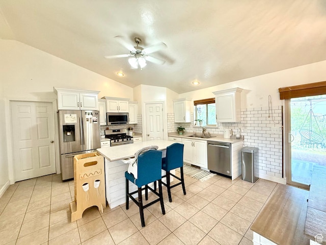 301 S 1350 W, Vernal, UT 84078 - kitchen featuring appliances with stainless steel finishes, vaulted ceiling, ceiling fan, tasteful backsplash, and light countertops