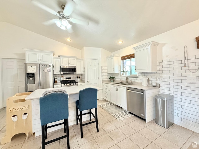 301 S 1350 W, Vernal, UT 84078 - kitchen with stainless steel appliances, lofted ceiling, light countertops, a ceiling fan, and light tile patterned floors