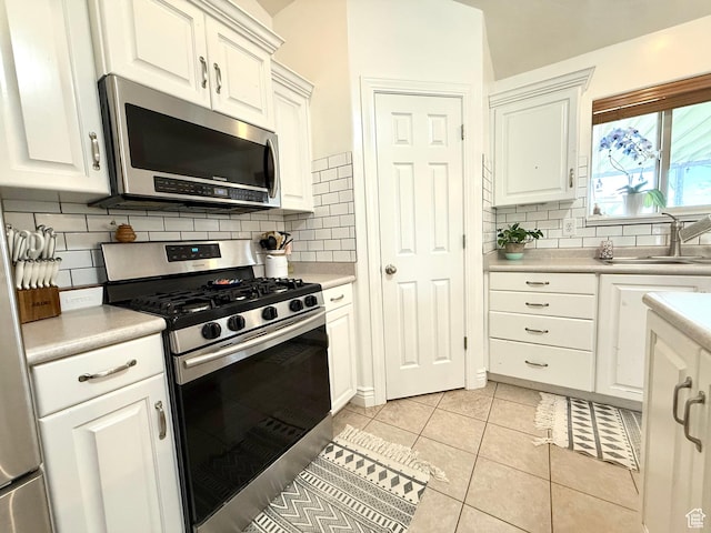 301 S 1350 W, Vernal, UT 84078 - kitchen featuring stainless steel appliances, light countertops, tasteful backsplash, white cabinetry, and light tile patterned floors