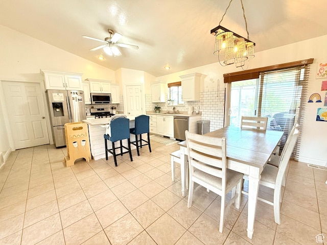 301 S 1350 W, Vernal, UT 84078 - dining area with lofted ceiling, light tile patterned floors, ceiling fan, and a chandelier