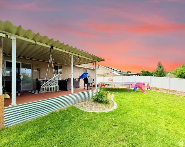 301 S 1350 W, Vernal, UT 84078 - yard at dusk with a trampoline, a fenced backyard, and a patio area