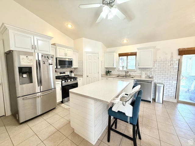 301 S 1350 W, Vernal, UT 84078 - kitchen featuring appliances with stainless steel finishes, lofted ceiling, light countertops, tasteful backsplash, and light tile patterned floors