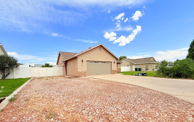 301 S 1350 W, Vernal, UT 84078 - view of front facade with concrete driveway, stucco siding, a garage, and stone siding