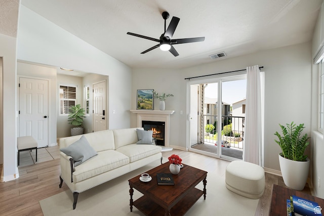 3760 S Carlisle Park Pl W Unit 3, Salt Lake City, UT 84119 - living area with light wood-style floors, a glass covered fireplace, ceiling fan, and vaulted ceiling