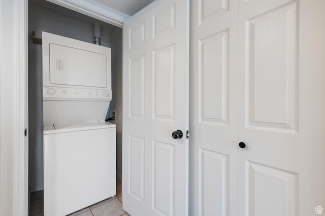 3760 S Carlisle Park Pl W Unit 3, Salt Lake City, UT 84119 - washroom with estacked washer and dryer and light tile patterned floors