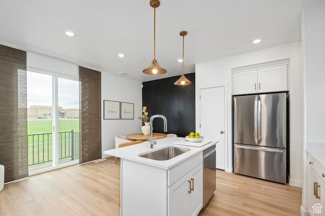6031 W Highlandbrook Dr, West Jordan, UT 84081 - kitchen with appliances with stainless steel finishes, light wood-type flooring, light countertops, pendant lighting, and recessed lighting