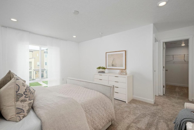 6031 W Highlandbrook Dr, West Jordan, UT 84081 - bedroom with light carpet, recessed lighting, a spacious closet, and a textured ceiling