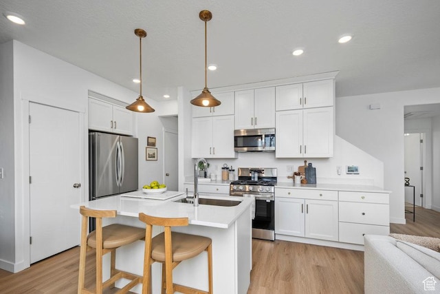 6031 W Highlandbrook Dr, West Jordan, UT 84081 - kitchen with appliances with stainless steel finishes, light wood-type flooring, white cabinets, and recessed lighting