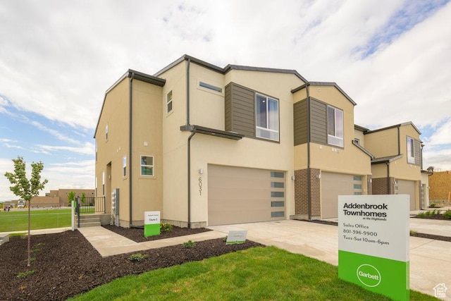 6031 W Highlandbrook Dr, West Jordan, UT 84081 - multi unit property with an attached garage, concrete driveway, and stucco siding