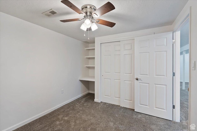 1414 E 275 N, Layton, UT 84040 - unfurnished bedroom featuring dark carpet, a textured ceiling, a closet, and a ceiling fan