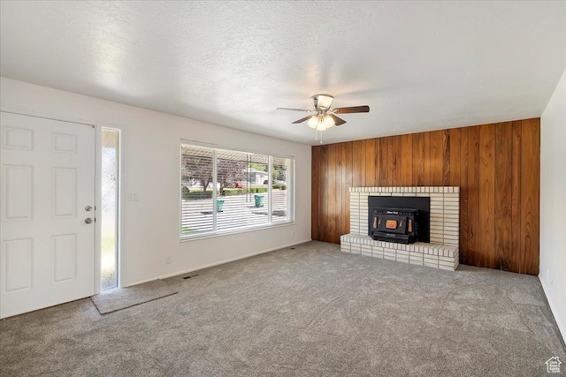 1414 E 275 N, Layton, UT 84040 - unfurnished living room featuring a wood stove, carpet floors, ceiling fan, and wood walls