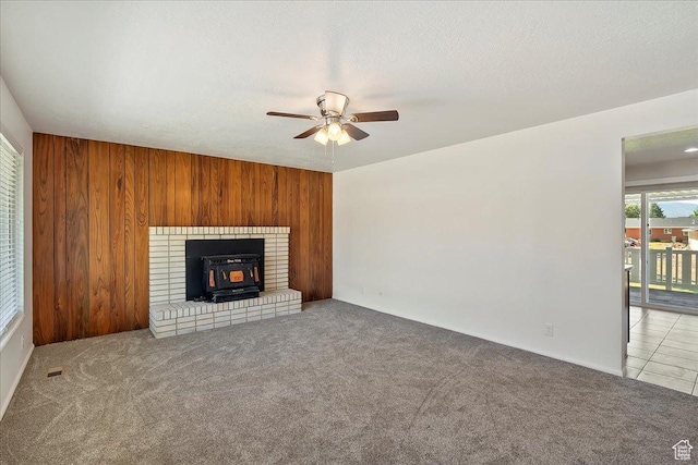 1414 E 275 N, Layton, UT 84040 - unfurnished living room featuring a wood stove, a ceiling fan, carpet, and wooden walls
