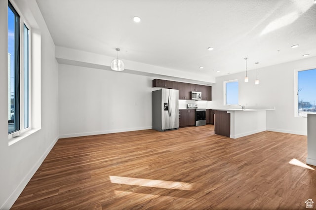 1034 W 1700 S Unit 124, Salt Lake City, UT 84104 - unfurnished living room featuring light wood-type flooring and recessed lighting