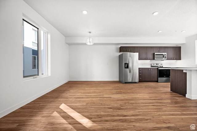 1034 W 1700 S Unit 124, Salt Lake City, UT 84104 - kitchen featuring appliances with stainless steel finishes, dark brown cabinets, light countertops, light wood-type flooring, and recessed lighting