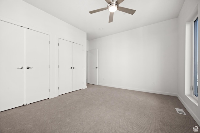 1034 W 1700 S Unit 124, Salt Lake City, UT 84104 - unfurnished bedroom with two closets, carpet, and ceiling fan