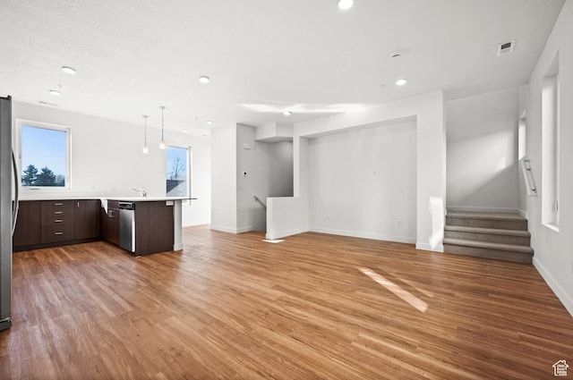 1034 W 1700 S Unit 124, Salt Lake City, UT 84104 - unfurnished living room featuring light wood-type flooring, recessed lighting, and stairway