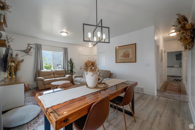 408 S Red Rock Dr W Unit 164, Santaquin, UT 84655 - dining space featuring light wood-style flooring and a chandelier