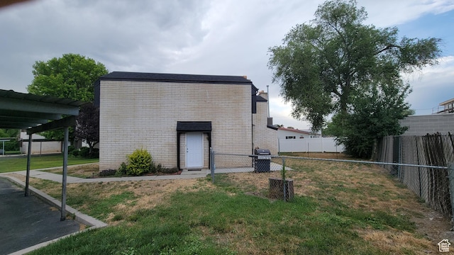 4531 S 700th St E, Murray, UT 84107 - rear view of property featuring brick siding and a fenced backyard