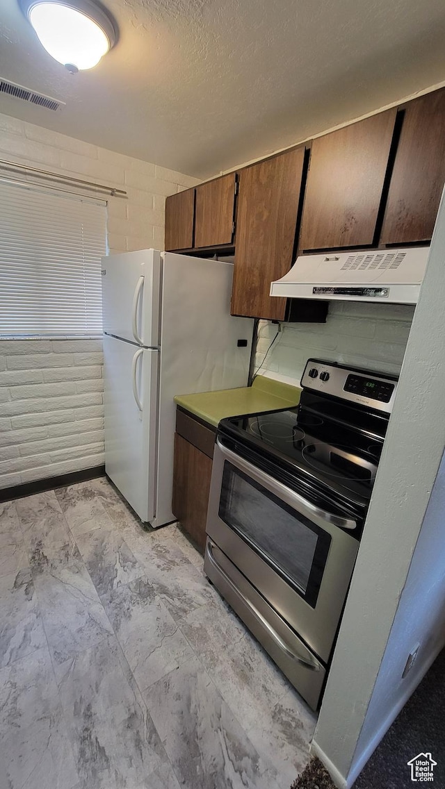 4531 S 700th St E, Murray, UT 84107 - kitchen with stainless steel electric range oven, under cabinet range hood, and freestanding refrigerator