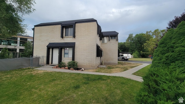 4531 S 700th St E, Murray, UT 84107 - rear view of property featuring brick siding and roof with shingles