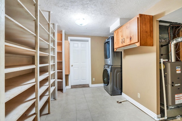 728 S 300 W, Payson, UT 84651 - laundry area featuring stacked washer and clothes dryer, cabinet space, and light tile patterned floors