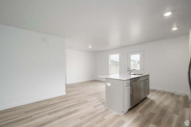 1857 E Bison Dr Unit B217, Eagle Mountain, UT 84005 - kitchen featuring stainless steel dishwasher, light wood-type flooring, a kitchen island with sink, light countertops, and recessed lighting