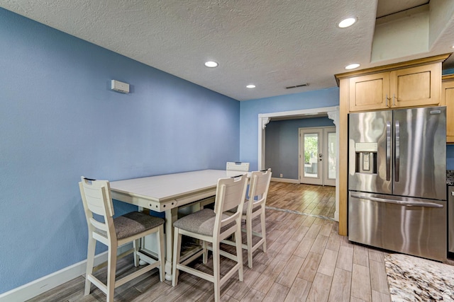 709 N 2200 E, St George, UT 84790 - dining area with light wood-style floors, a textured ceiling, recessed lighting, and french doors