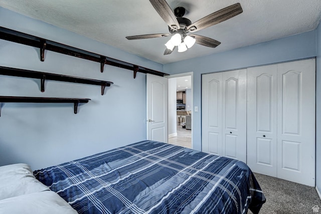 709 N 2200 E, St George, UT 84790 - bedroom featuring light carpet, a closet, a ceiling fan, a barn door, and a textured ceiling