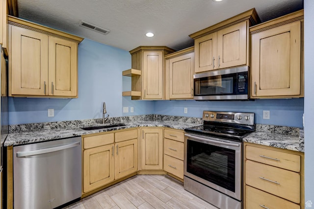 709 N 2200 E, St George, UT 84790 - kitchen featuring stainless steel appliances, light brown cabinetry, open shelves, light stone counters, and recessed lighting