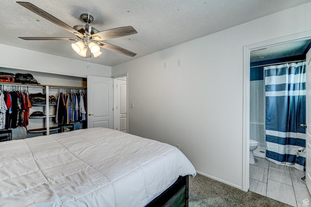 709 N 2200 E, St George, UT 84790 - carpeted bedroom with a closet, ensuite bathroom, a textured ceiling, and ceiling fan