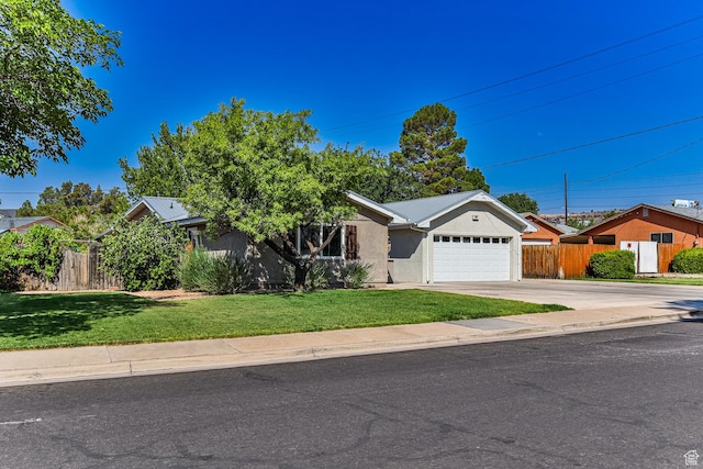 709 N 2200 E, St George, UT 84790 - view of front of property featuring stucco siding, a garage, and concrete driveway