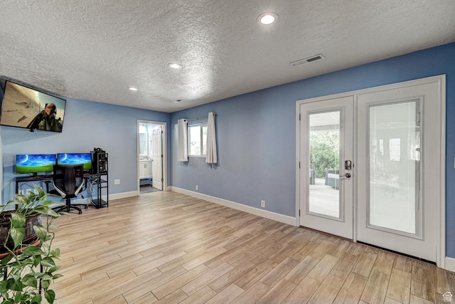 709 N 2200 E, St George, UT 84790 - unfurnished living room featuring a textured ceiling, french doors, wood finished floors, an office area, and recessed lighting