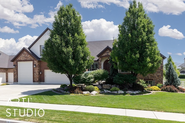 2124 N Heritage Dr, Farr West, UT 84404 - view of front of home featuring stone siding, a front lawn, concrete driveway, and a garage
