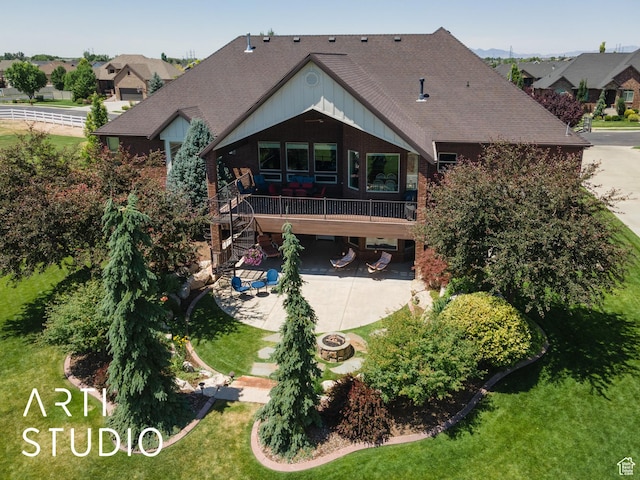 2124 N Heritage Dr, Farr West, UT 84404 - back of property with a patio area, roof with shingles, driveway, stairs, and a lawn