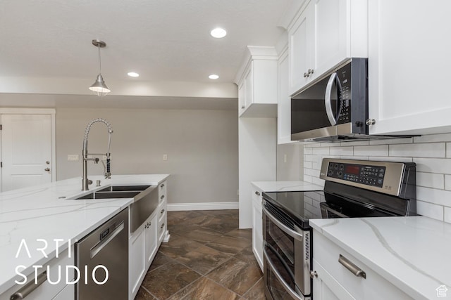 2124 N Heritage Dr, Farr West, UT 84404 - kitchen with appliances with stainless steel finishes, recessed lighting, white cabinetry, light stone countertops, and dark stone finish floors