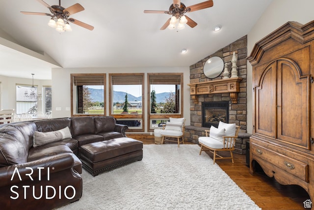 2124 N Heritage Dr, Farr West, UT 84404 - living area with lofted ceiling, ceiling fan, plenty of natural light, wood finished floors, and a stone fireplace