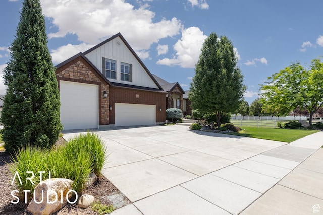 2124 N Heritage Dr, Farr West, UT 84404 - view of front of house featuring board and batten siding, driveway, brick siding, and a garage