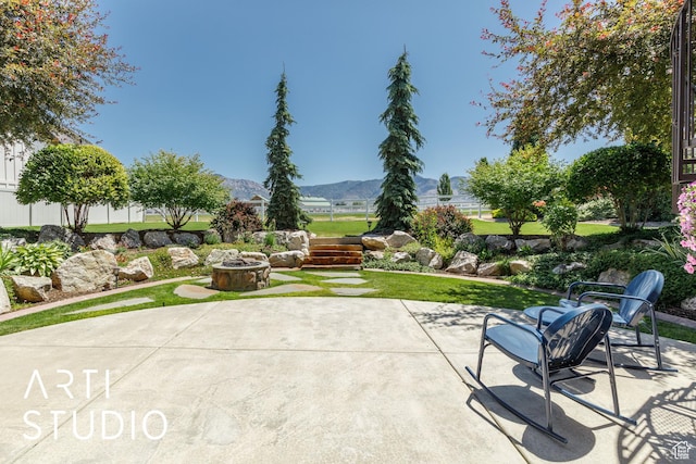 2124 N Heritage Dr, Farr West, UT 84404 - view of patio with a fire pit and a mountain view