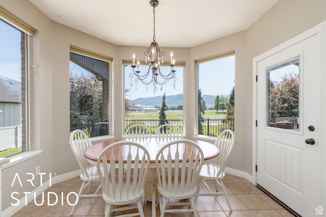 2124 N Heritage Dr, Farr West, UT 84404 - dining space featuring light tile patterned flooring, a chandelier, and a mountain view