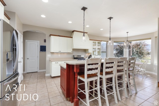 2124 N Heritage Dr, Farr West, UT 84404 - kitchen with appliances with stainless steel finishes, arched walkways, light countertops, light tile patterned floors, and recessed lighting