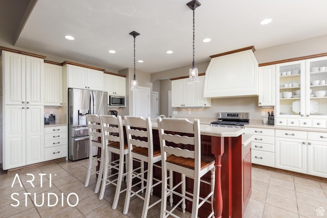2124 N Heritage Dr, Farr West, UT 84404 - kitchen featuring appliances with stainless steel finishes, custom exhaust hood, light tile patterned flooring, light countertops, and an island with sink