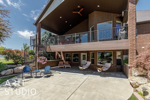 2124 N Heritage Dr, Farr West, UT 84404 - back of house featuring brick siding, a patio, stairs, ceiling fan, and a balcony