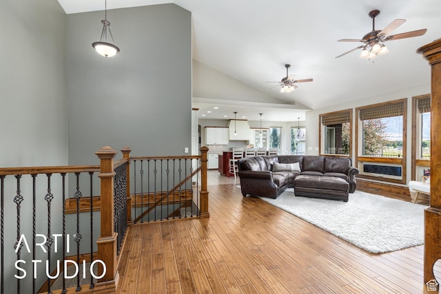 2124 N Heritage Dr, Farr West, UT 84404 - living room with plenty of natural light, a ceiling fan, hardwood / wood-style flooring, and high vaulted ceiling