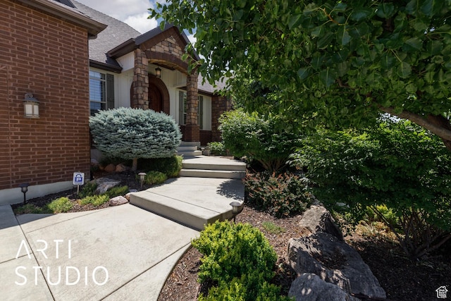 2124 N Heritage Dr, Farr West, UT 84404 - entrance to property featuring stone siding, roof with shingles, and brick siding