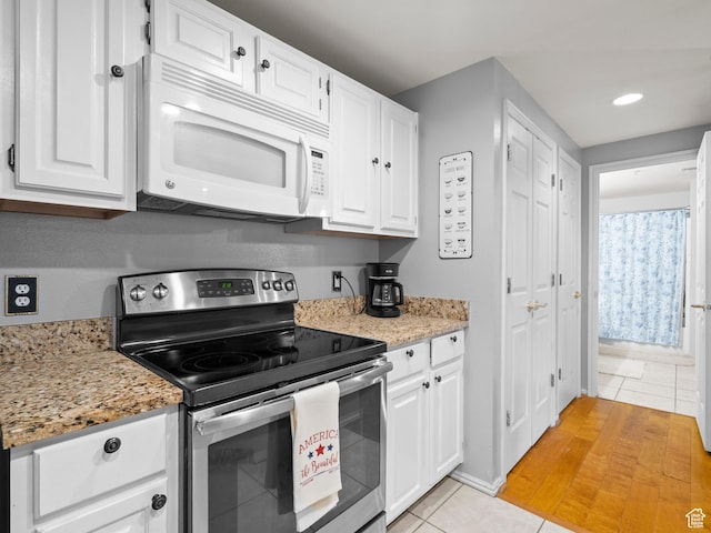 900 Bitner Rd Unit D 34, Park City, UT 84098 - kitchen with stainless steel electric stove, white microwave, light tile patterned floors, white cabinets, and recessed lighting