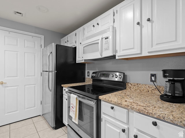 900 Bitner Rd Unit D 34, Park City, UT 84098 - kitchen with stainless steel range with electric cooktop, white microwave, white cabinets, light tile patterned floors, and light stone countertops