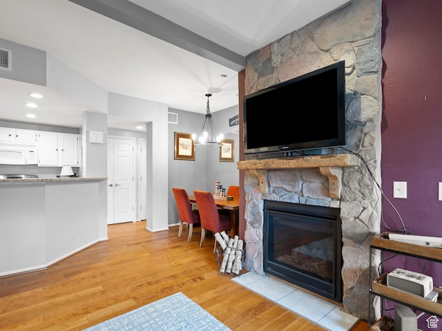 900 Bitner Rd Unit D 34, Park City, UT 84098 - living area with light wood-style flooring, a fireplace, and a chandelier
