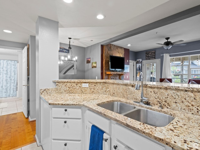 900 Bitner Rd Unit D 34, Park City, UT 84098 - kitchen featuring white cabinetry, a chandelier, light stone counters, light tile patterned floors, and recessed lighting